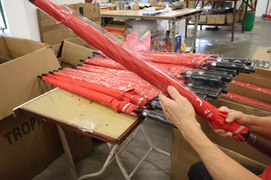 Quality check and packaging of branded umbrellas